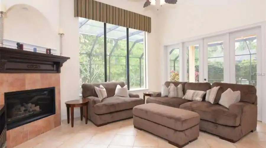 Family Room with Fireplace and doors to Outside Pool and Covered Dining area